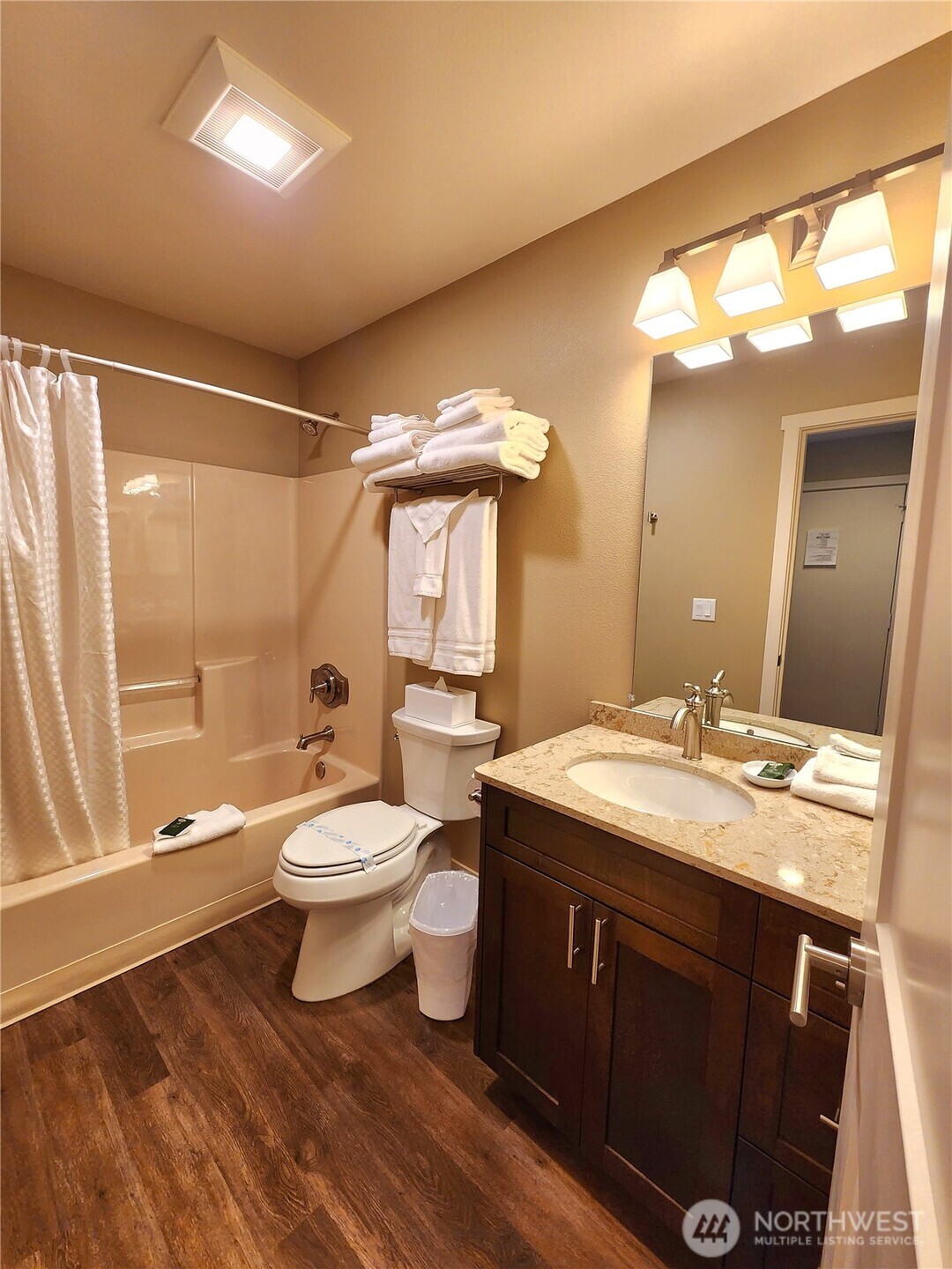 1 Lakeside 717-i Manson, WA 98831 - Photo 20 of 40 a bathroom with a granite countertop toilet a sink and a mirror