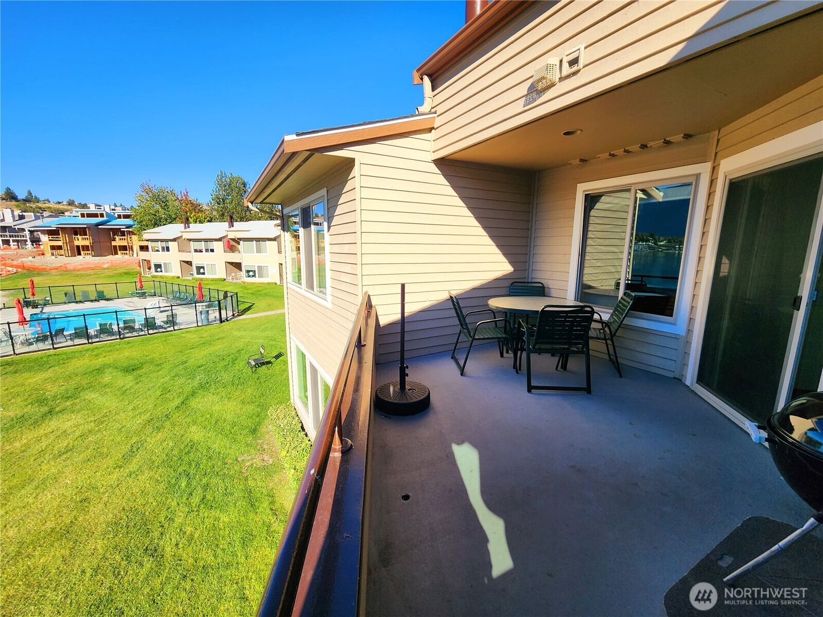 1 Lakeside 717-i Manson, WA 98831 - Photo 4 of 40 a view of a patio with table and chairs with wooden floor and fence