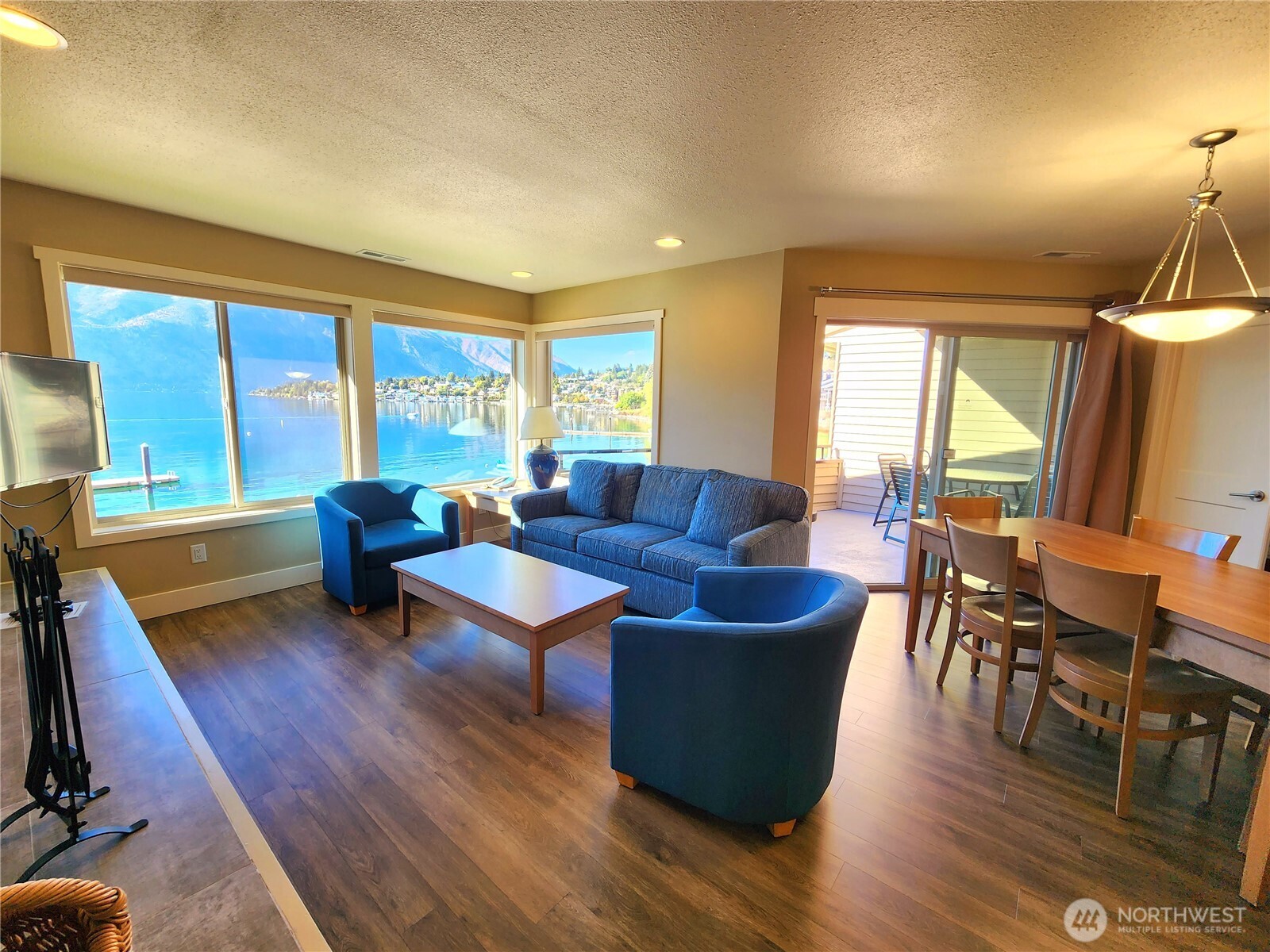 1 Lakeside 717-i Manson, WA 98831 - Photo 8 of 40 a living room with furniture a wooden floor and a large window