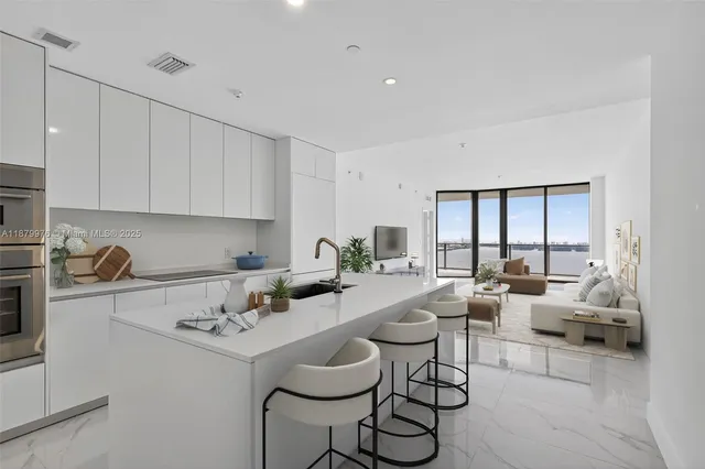a living room with furniture and a kitchen island