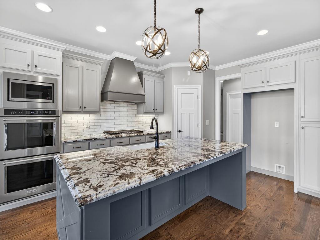 436 Thunder Road Buford, GA 30518 - Photo 13 of 62 a kitchen with kitchen island granite countertop a center island and stainless steel appliances