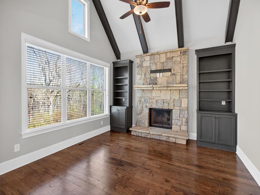 436 Thunder Road Buford, GA 30518 - Photo 16 of 62 a view of an empty room with wooden floor fireplace and a window