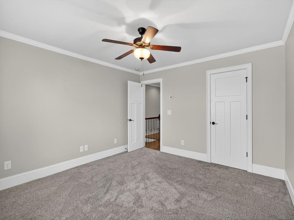 436 Thunder Road Buford, GA 30518 - Photo 22 of 62 a view of an empty room with a ceiling fan and window