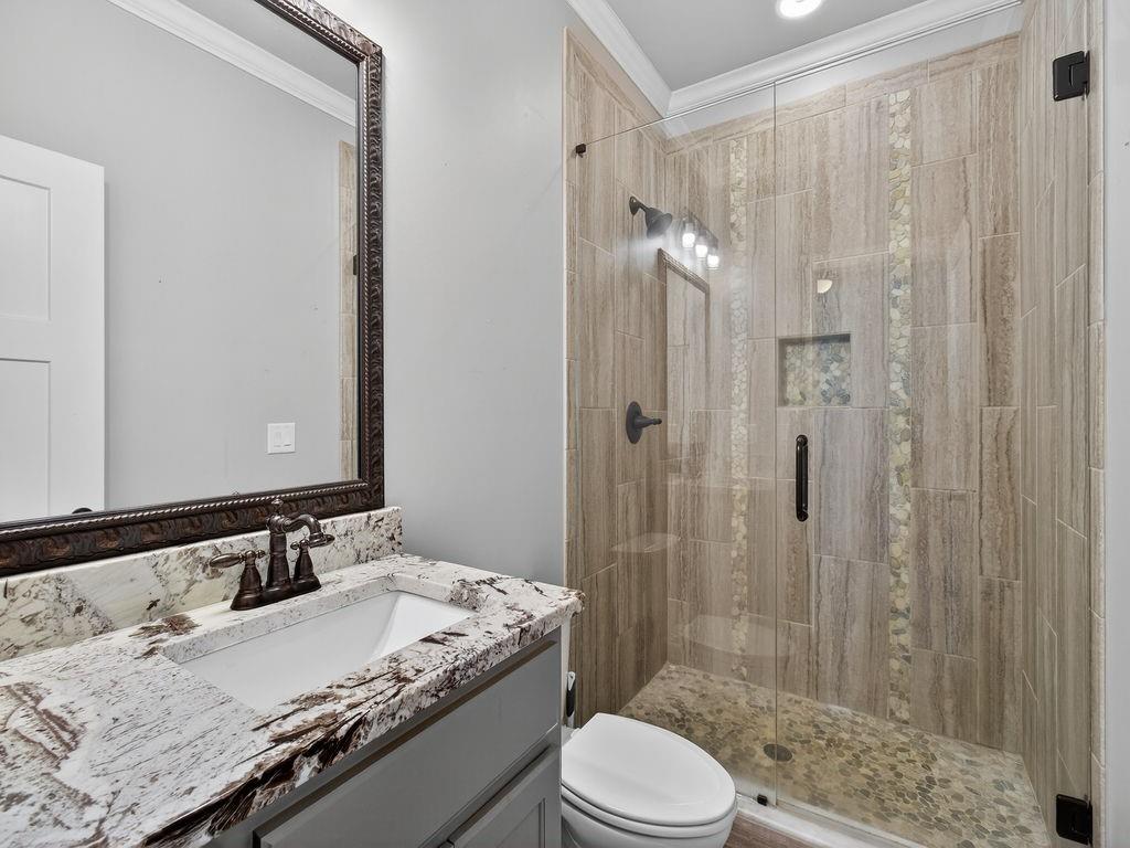 436 Thunder Road Buford, GA 30518 - Photo 27 of 62 a bathroom with a granite countertop sink toilet and shower