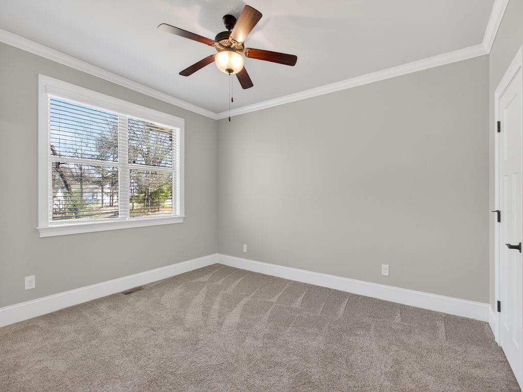 436 Thunder Road Buford, GA 30518 - Photo 28 of 62 an empty room with a window and a fan