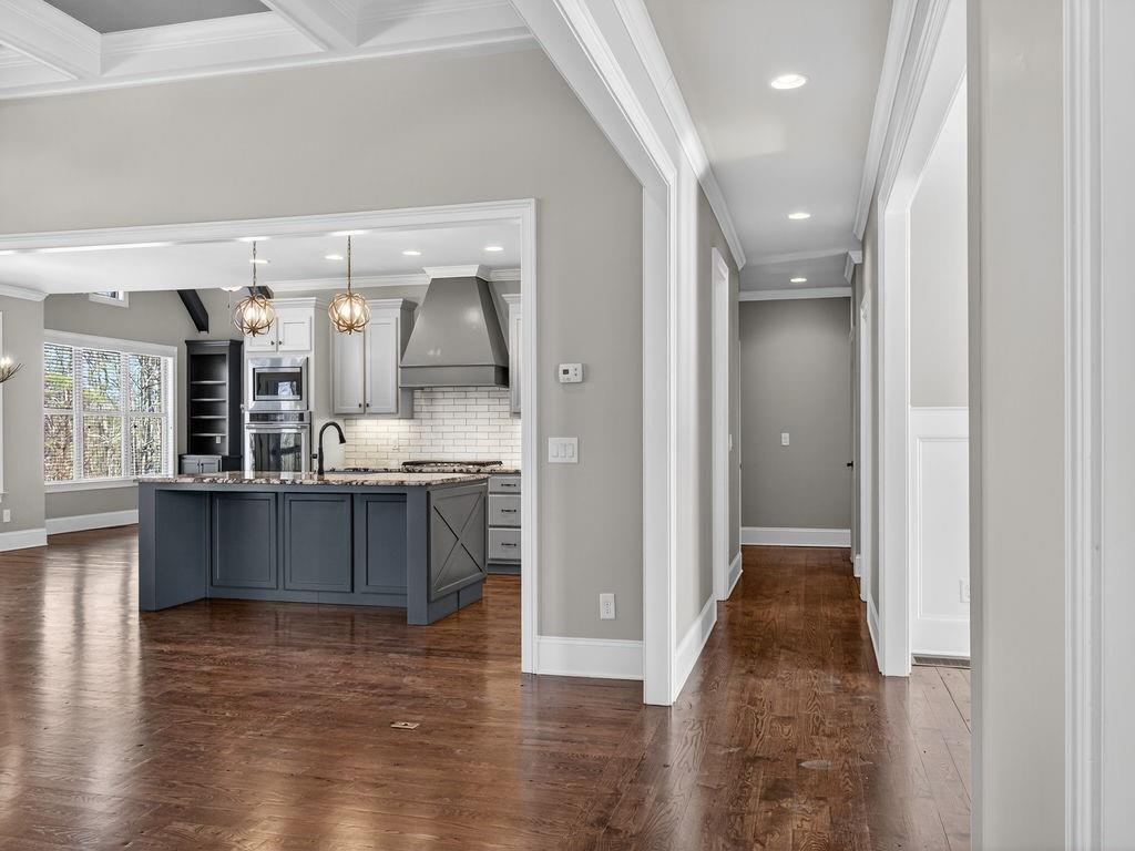 436 Thunder Road Buford, GA 30518 - Photo 31 of 62 a view of kitchen and living room with wooden floor