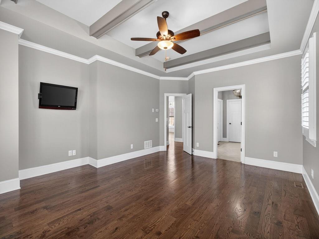 436 Thunder Road Buford, GA 30518 - Photo 35 of 62 a view of an empty room with wooden floor and a ceiling fan