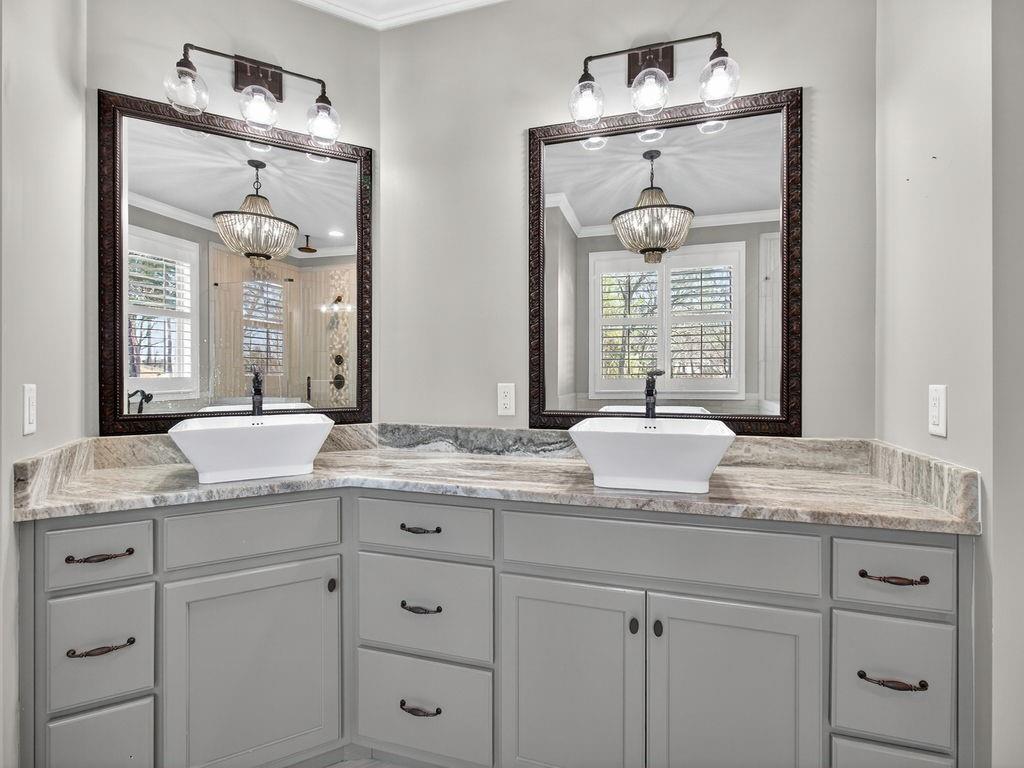 436 Thunder Road Buford, GA 30518 - Photo 38 of 62 a bathroom with double vanity sinks a vanity a lamp and a mirror