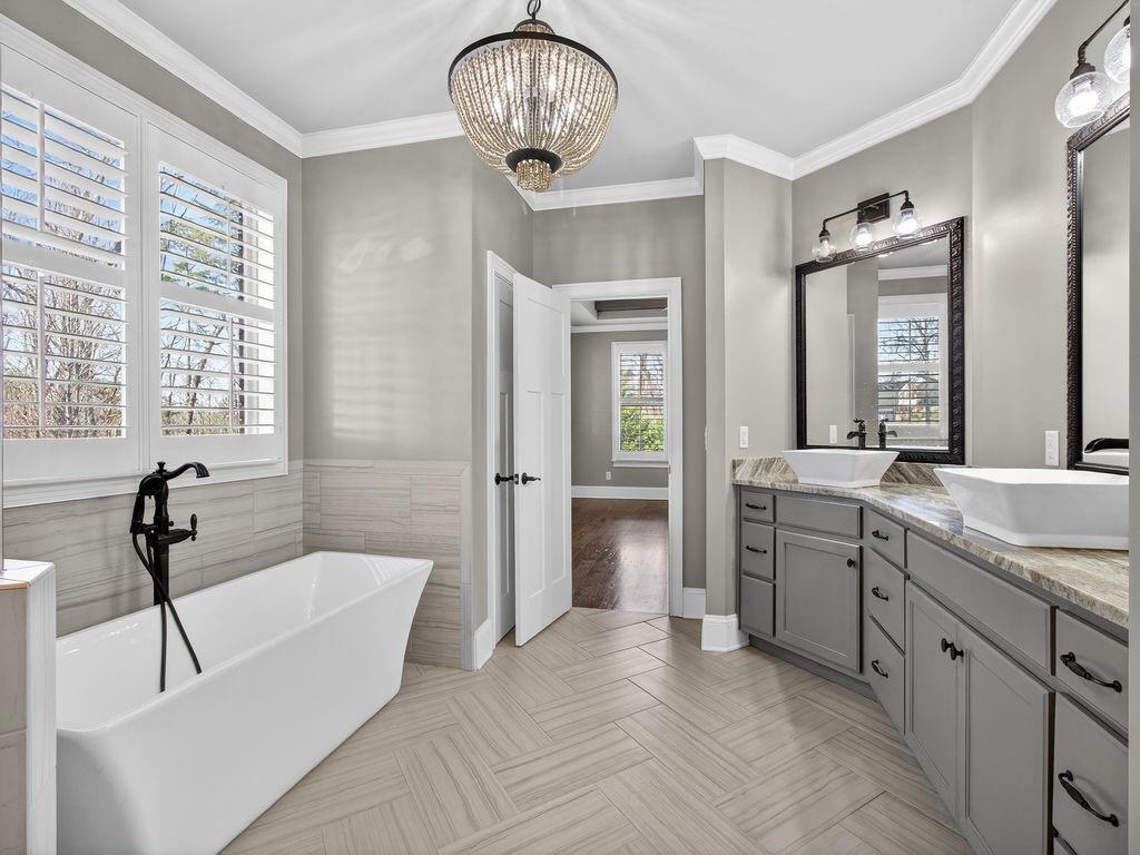 436 Thunder Road Buford, GA 30518 - Photo 39 of 62 a spacious bathroom with a tub sink and mirror