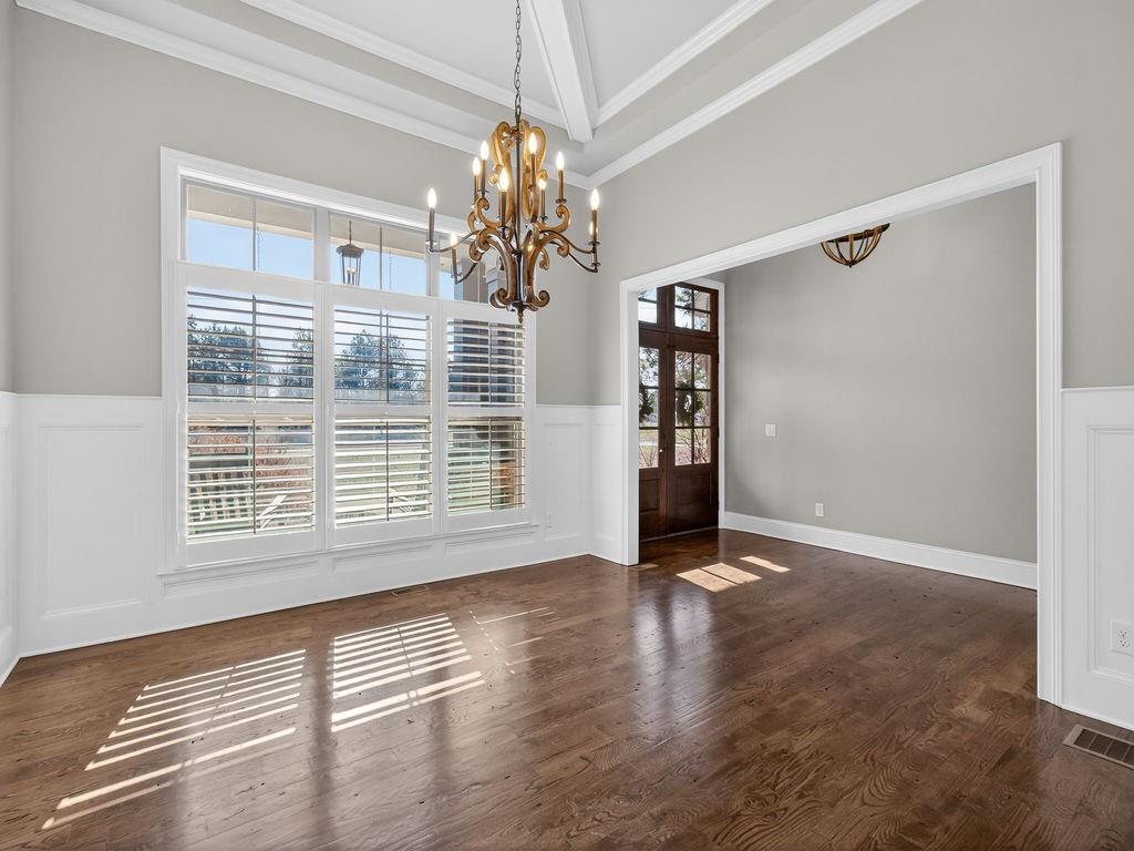 436 Thunder Road Buford, GA 30518 - Photo 7 of 62 a view of an empty room with chandelier and a window