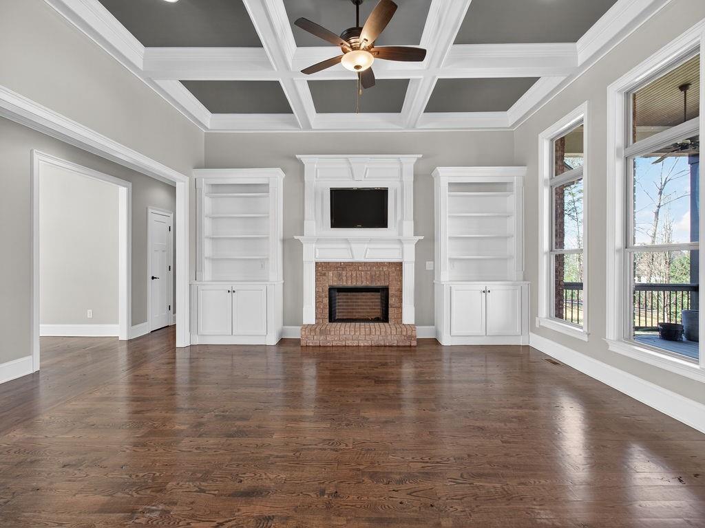 436 Thunder Road Buford, GA 30518 - Photo 10 of 62 a view of an empty room with wooden floor and a window