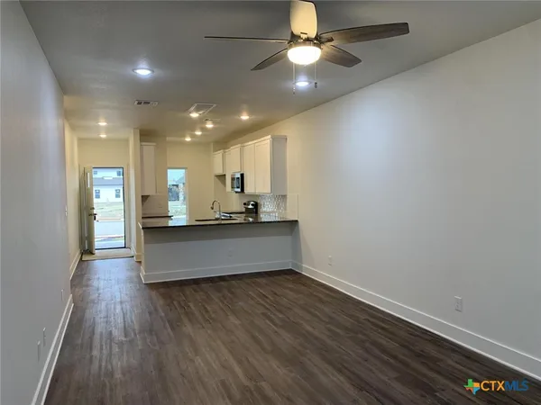 a view of kitchen with cabinets and wooden floor