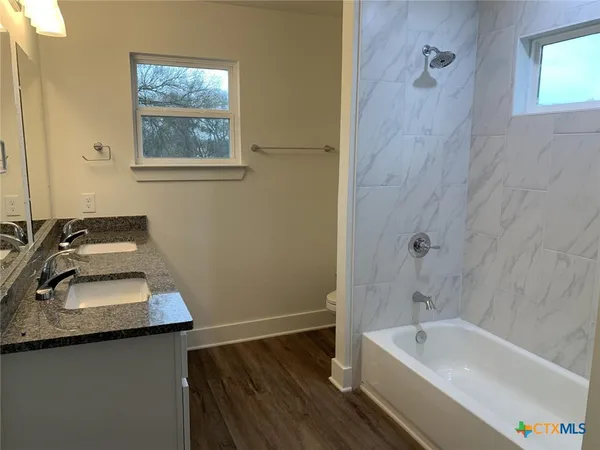 a bathroom with a sink a bathtub and a toilet