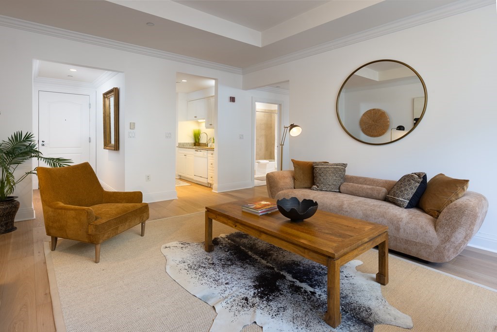 1 Huntington Avenue, Unit 401 Boston, MA 02116 - Photo 4 of 11 a living room with furniture and a mirror