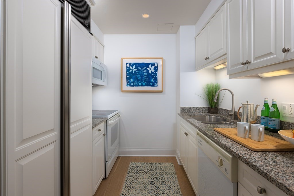 1 Huntington Avenue, Unit 401 Boston, MA 02116 - Photo 5 of 11 a kitchen with sink and mirror