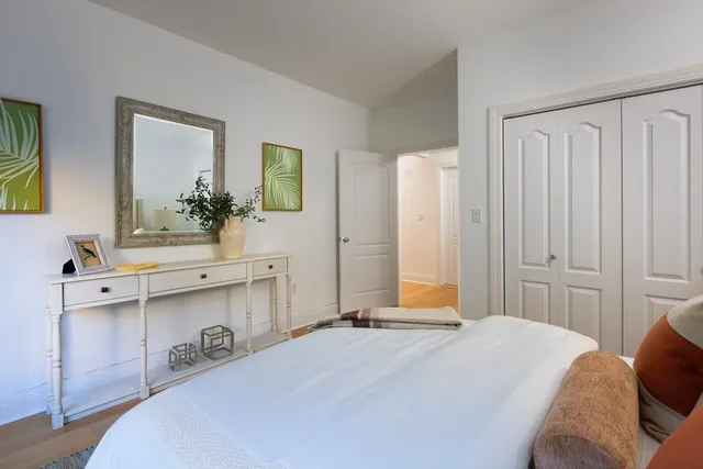 a bedroom with a bed and a dresser