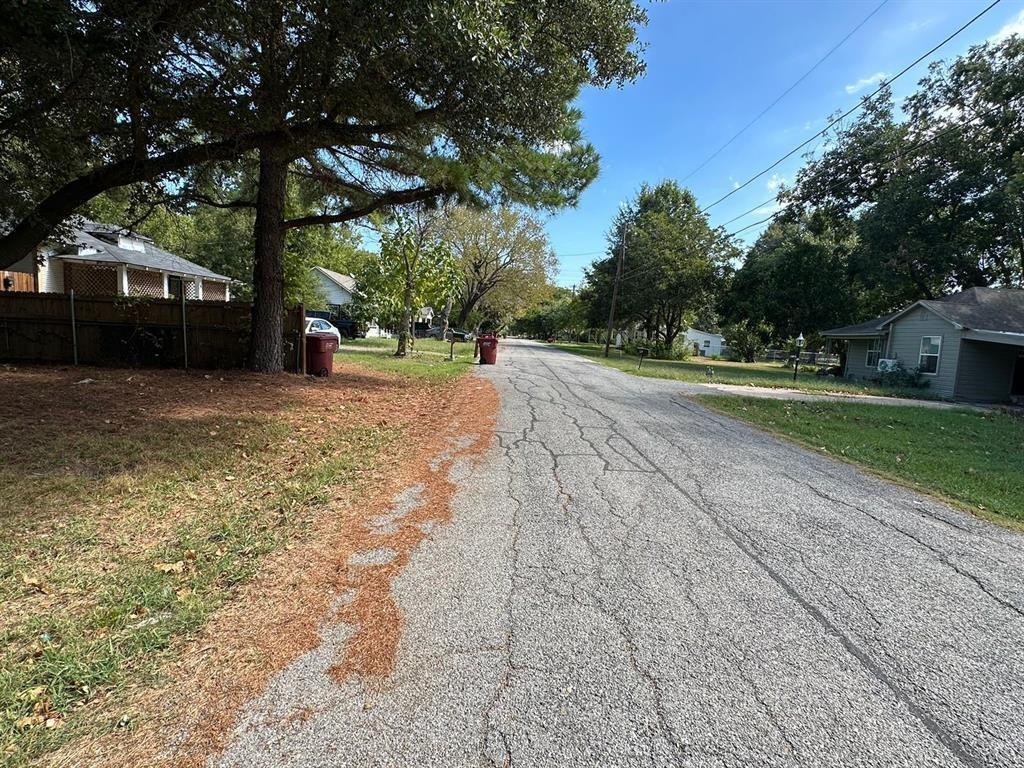 1306 South 5th Street Bonham, TX 75418 - Photo 13 of 13 a view of a yard with plants and trees