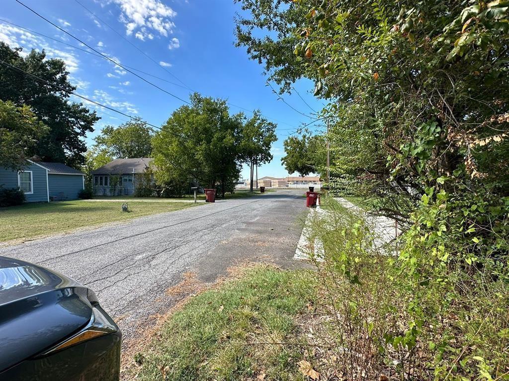 1306 South 5th Street Bonham, TX 75418 - Photo 10 of 13 a view of a yard with plants and trees