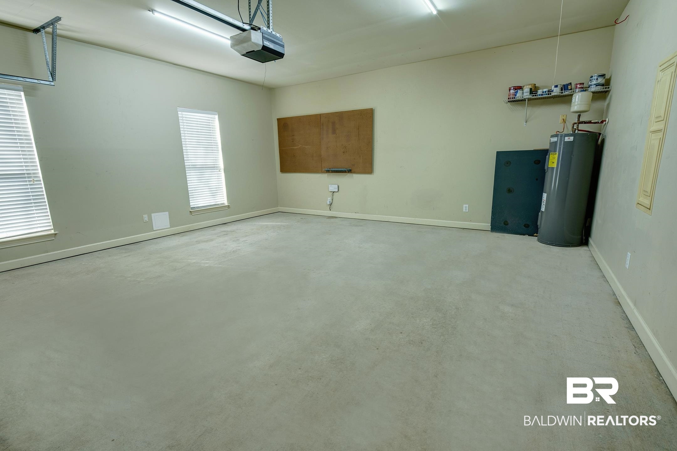 9421 Collier Loop Daphne, AL 36526 - Photo 29 of 31 Garage with electric water heater and a garage door opener