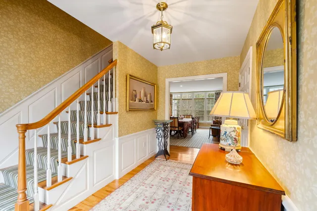 a view of a dining room with furniture and a chandelier