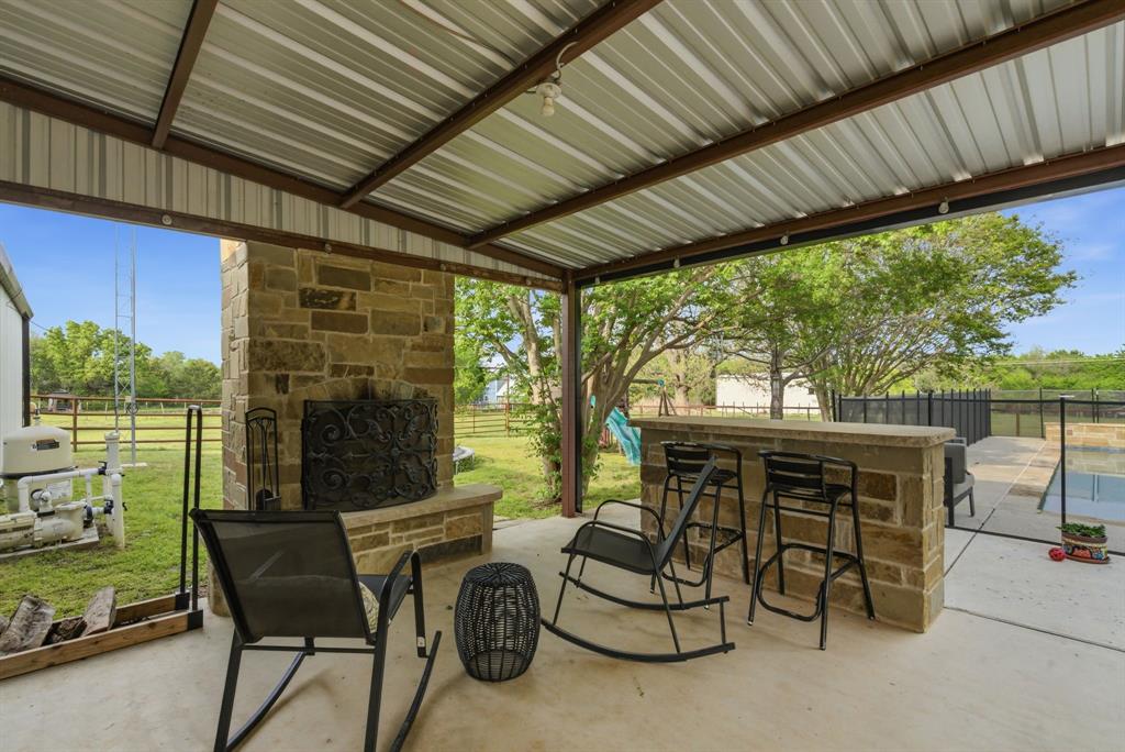 187 County Road 4195 Decatur, TX 76234 - Photo 5 of 40 a patio with table and chairs and potted plants
