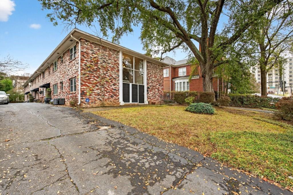 3668 Kingsboro Road Northeast, Unit 1 Atlanta, GA 30319 - Photo 6 of 43 a view of a building with a yard