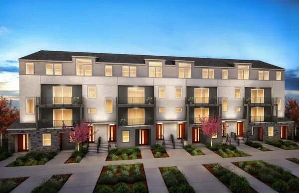 a front view of a residential apartment building with a yard