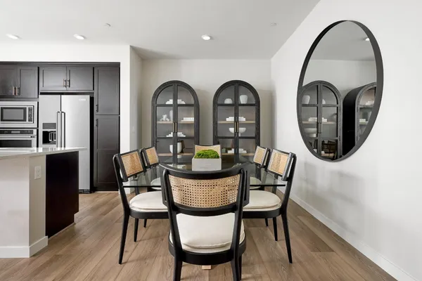 a view of a dining room with furniture and a mirror