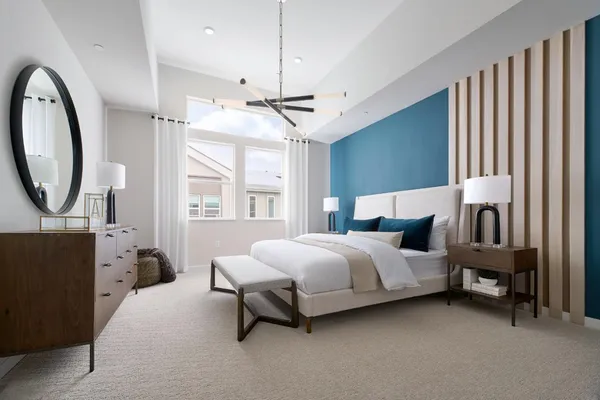 a spacious bedroom with a bed couch and a window