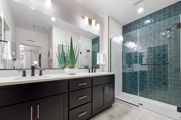 a bathroom with a double vanity sink mirror and double