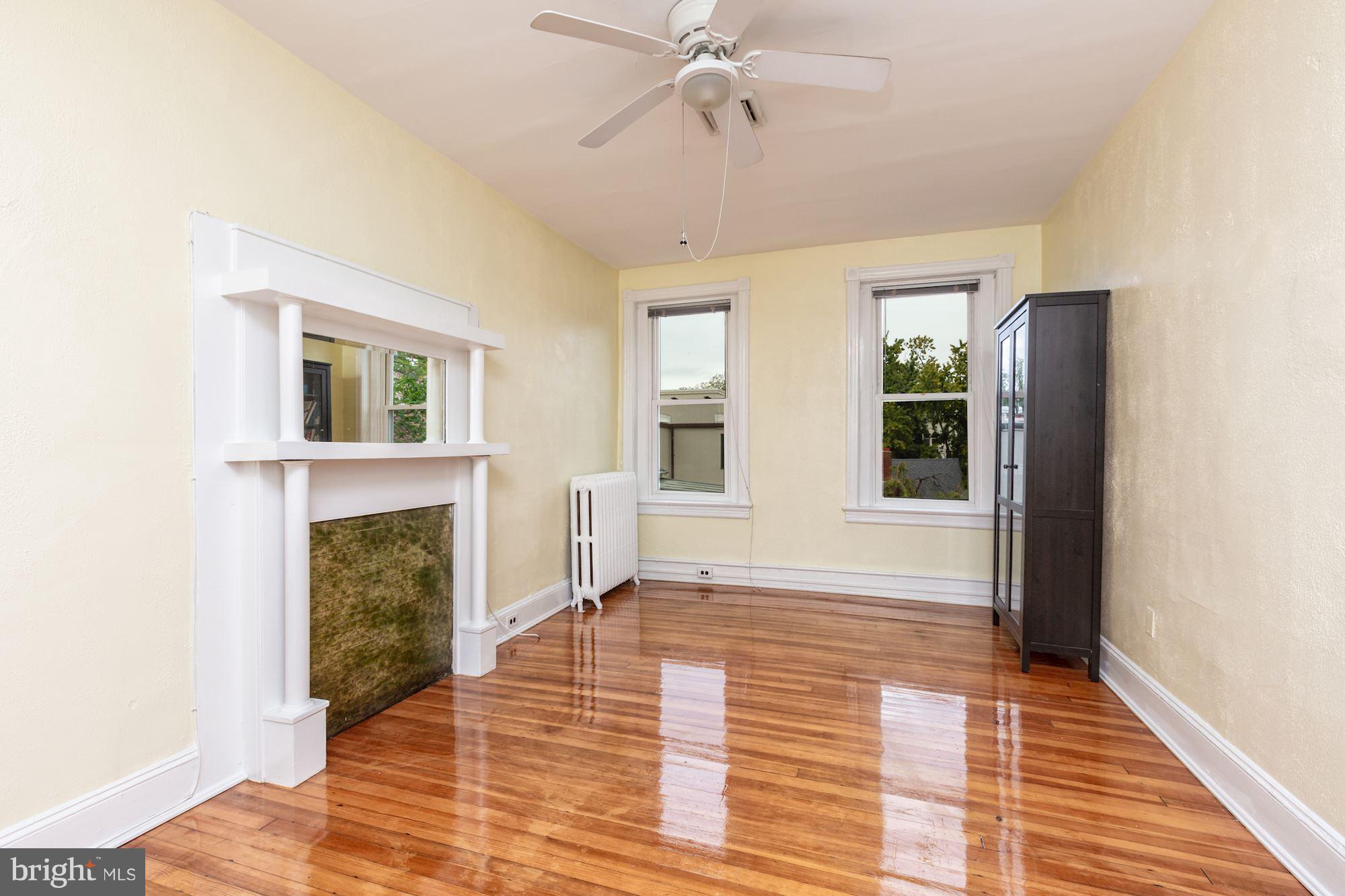 12 3rd Street Southeast Washington, DC 20003 - Photo 11 of 22 a view of an empty room with wooden floor fireplace and a window