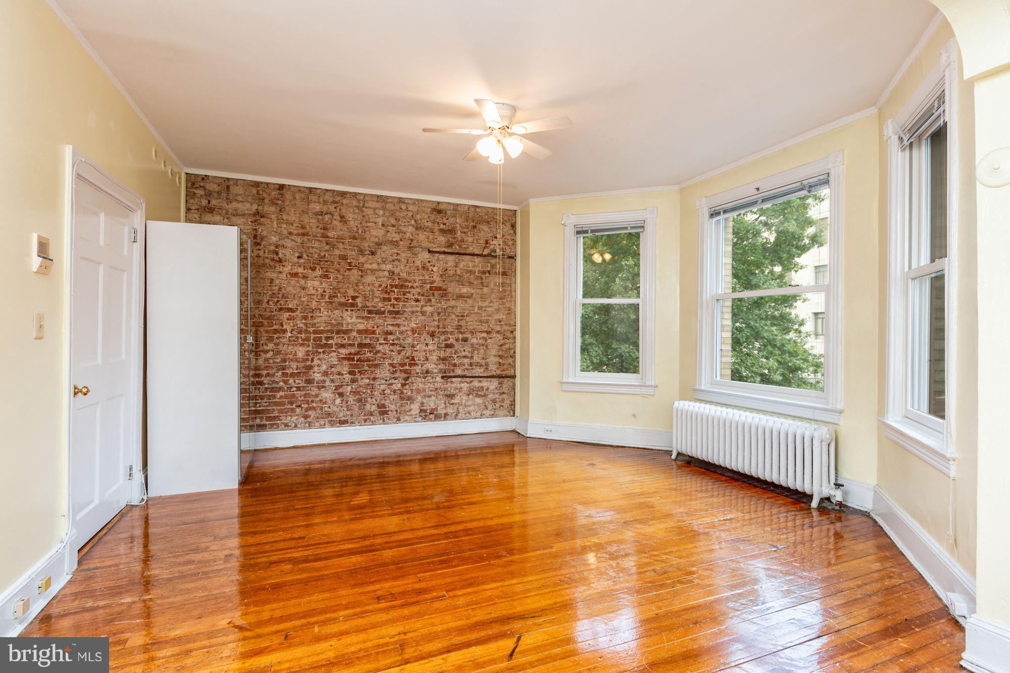 12 3rd Street Southeast Washington, DC 20003 - Photo 14 of 22 a view of an empty room with a window and wooden floor