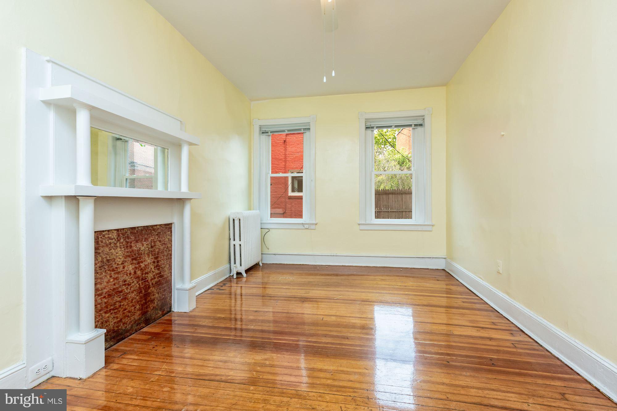 12 3rd Street Southeast Washington, DC 20003 - Photo 19 of 22 a view of an empty room with wooden floor fireplace and a window