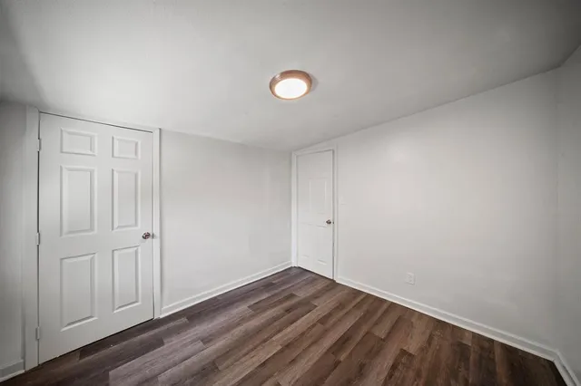 a view of room with wooden floor