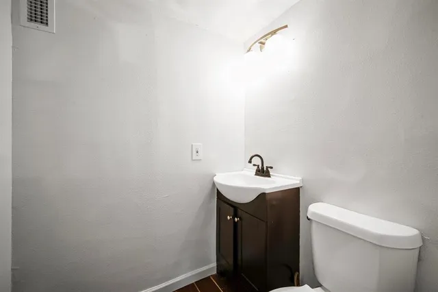a bathroom with a sink a toilet and a mirror