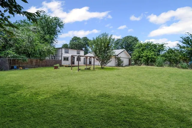 a view of a house with a yard and sitting area