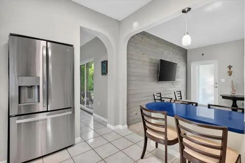 a kitchen with stainless steel appliances granite countertop a refrigerator a stove and a sink with granite countertops