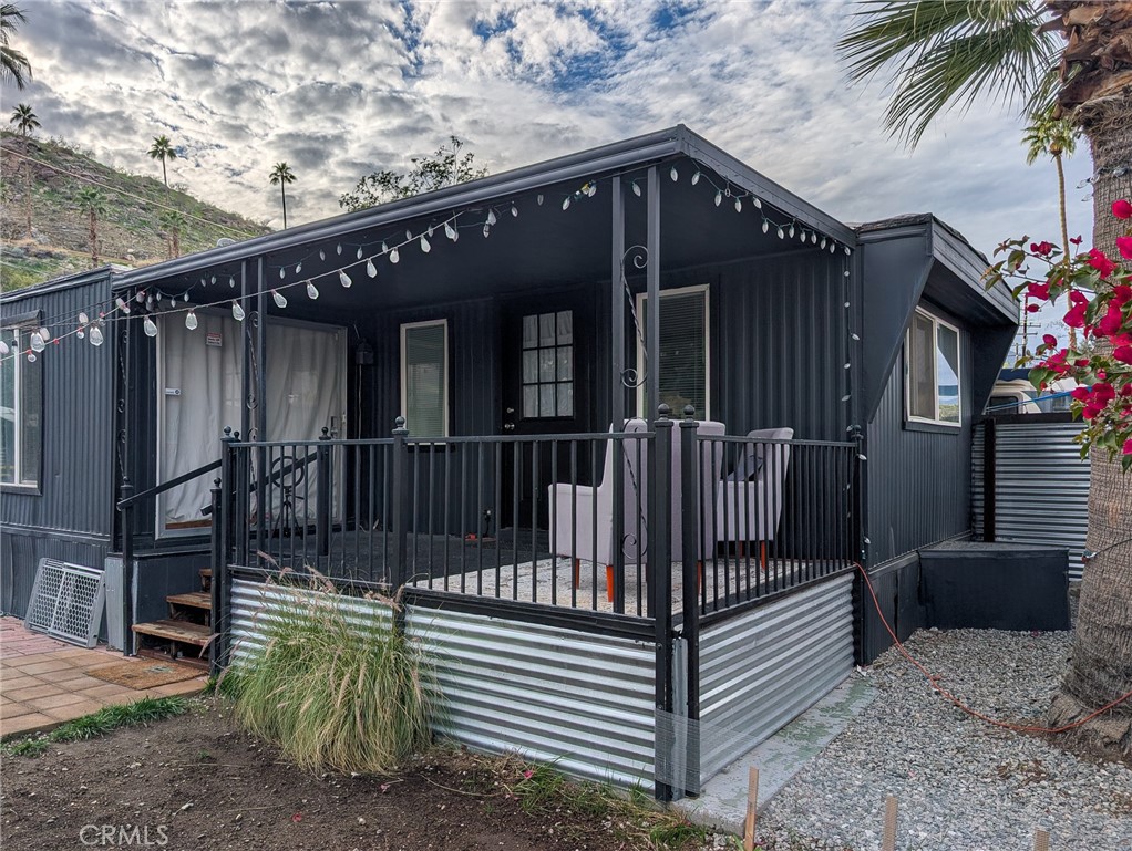 a view of a house with a small yard and wooden fence