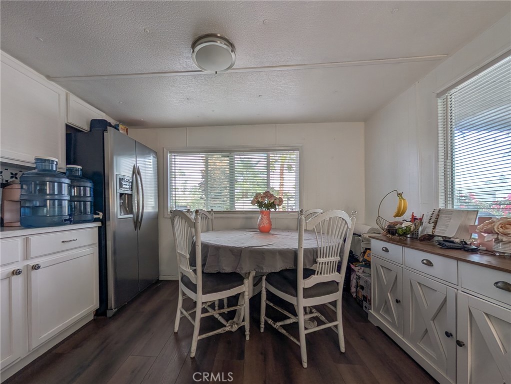 28 Jupiter Street Palm Springs, CA 92264 - Photo 3 of 26 a dining room with stainless steel appliances kitchen island granite countertop furniture and wooden floor