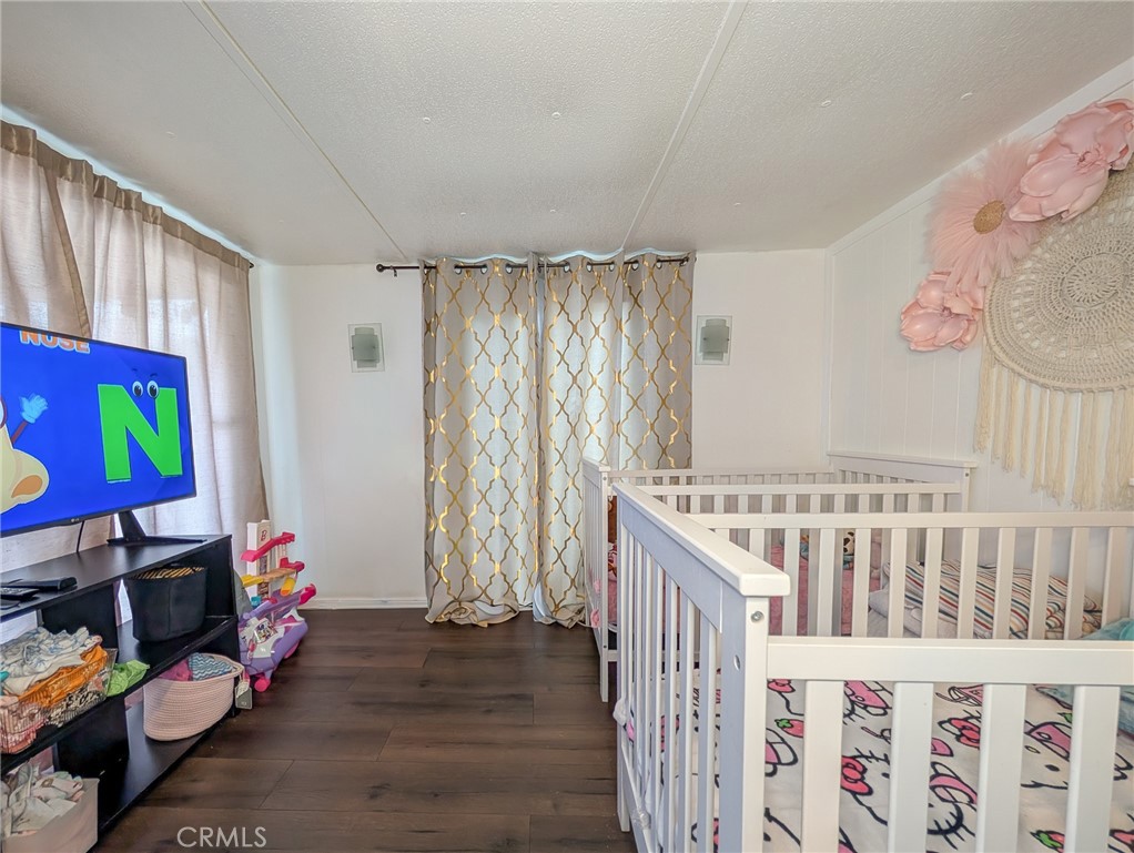 28 Jupiter Street Palm Springs, CA 92264 - Photo 6 of 26 a bedroom with furniture a baby crib and a window