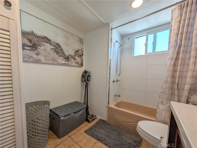 a bathroom with a tub a toilet and a shower