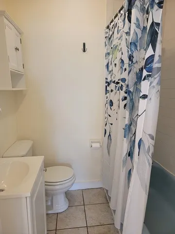 a white toilet sitting next to a bathroom sink