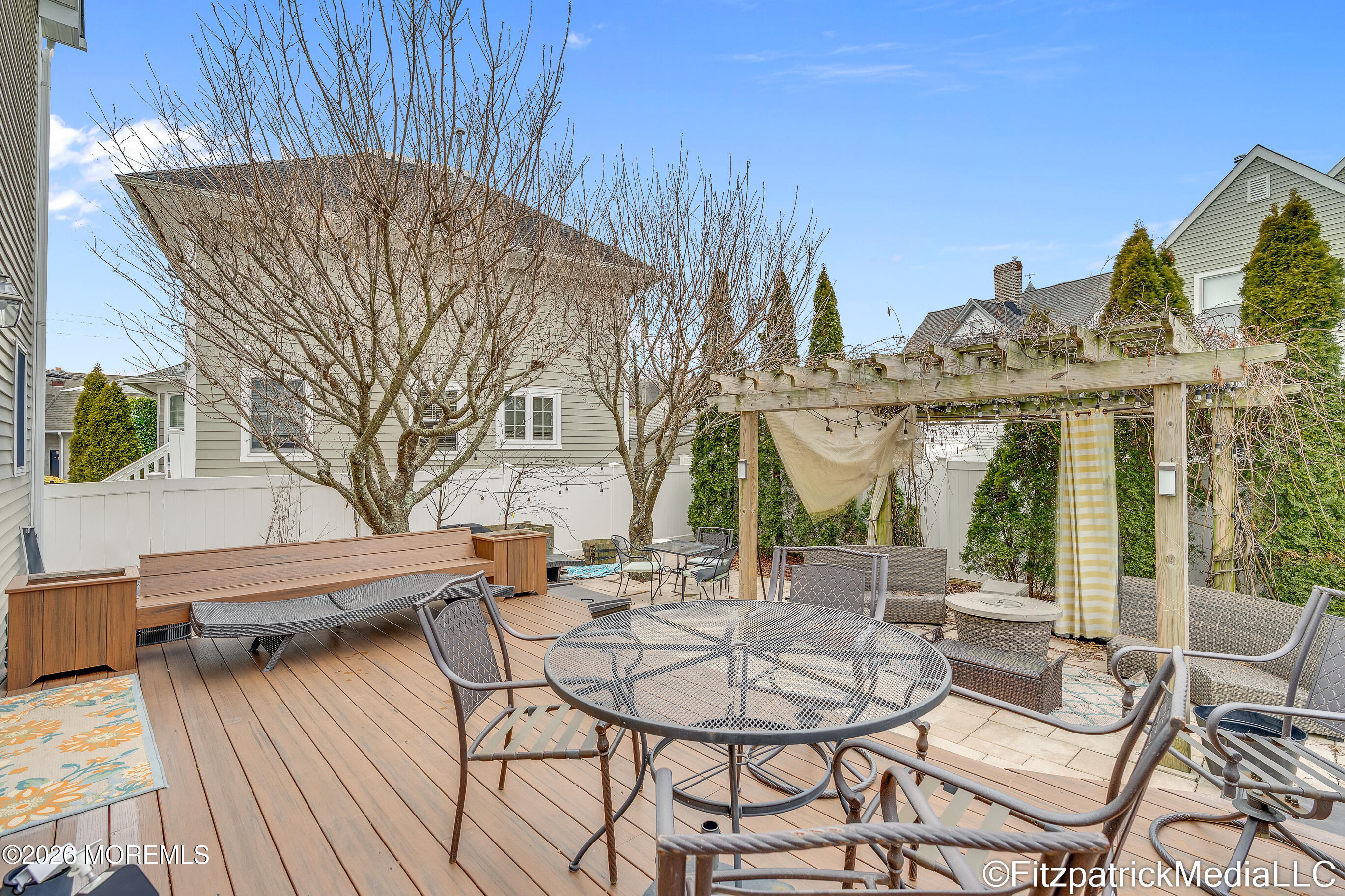 331 Richmond Avenue Point Pleasant Beach, NJ 08742 - Photo 11 of 46 a view of a patio with table and chairs and potted plants with wooden floor and fence