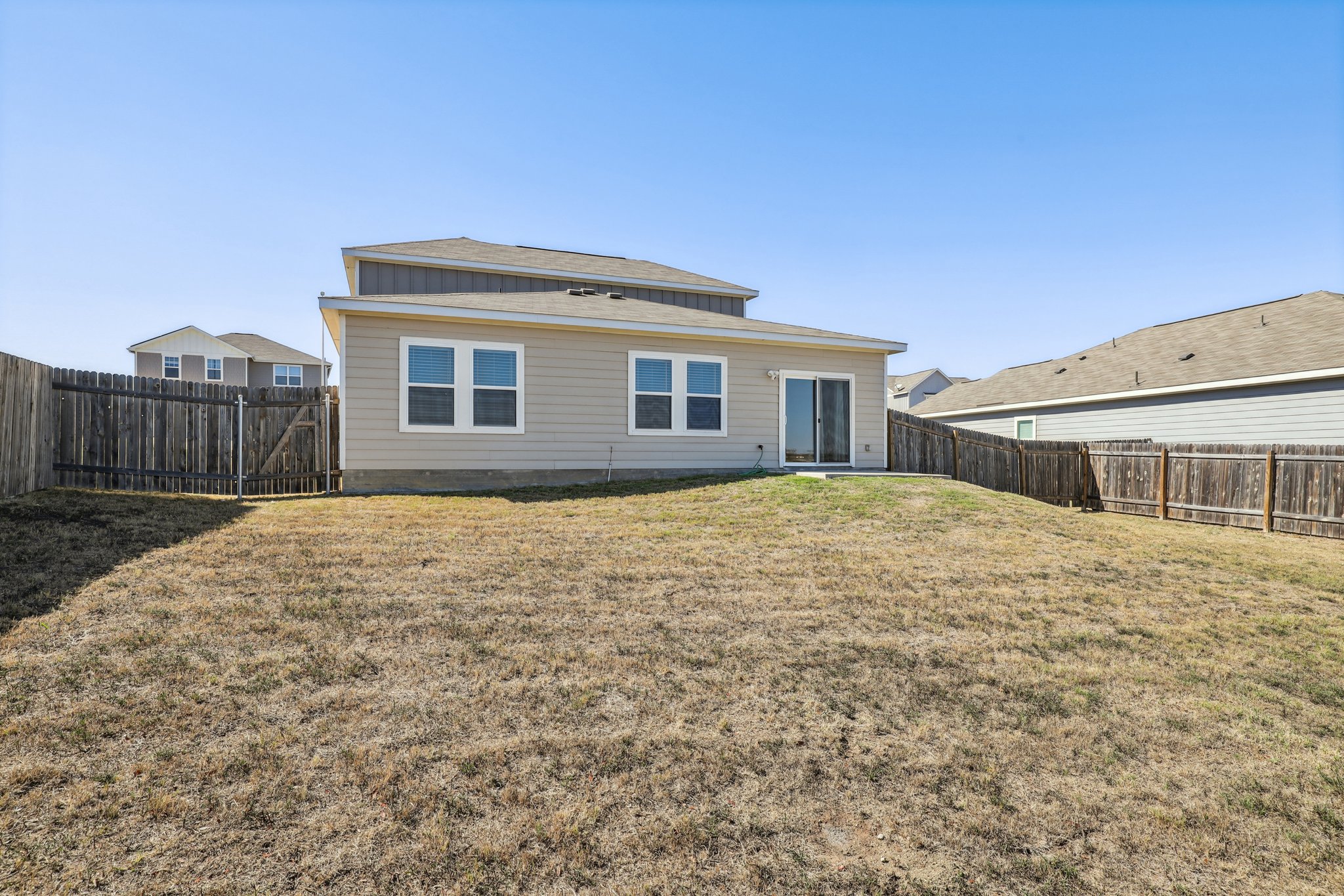 14105 Jeannette Rankin Rd Manor Manor, TX 78653 - Photo 16 of 29 Back of property featuring a fenced backyard