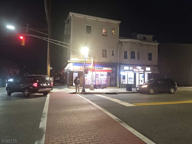 69 Passaic Street Garfield, NJ 07026 - Photo 1 of 6 a view of a building with cars parked on the road