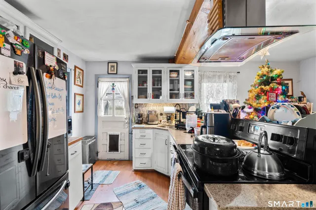 a kitchen filled with stainless steel appliances granite countertop a refrigerator and a stove