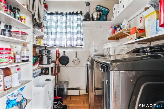 a work room with furniture a bookshelf and a window