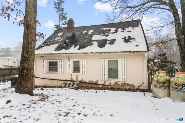 a view of a house with a snow in the yard