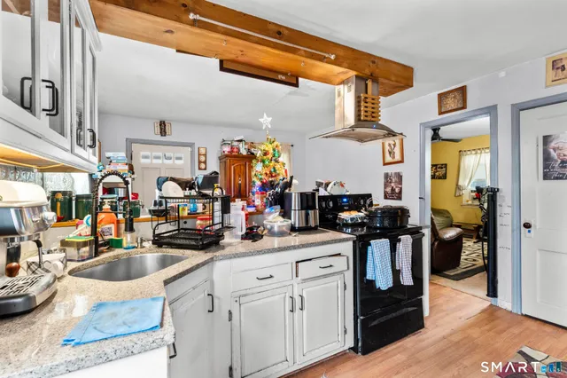a kitchen filled with a sink cabinets and appliances