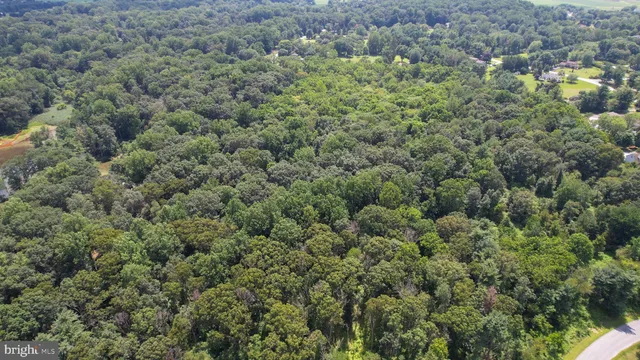an aerial view of a houses with a yard